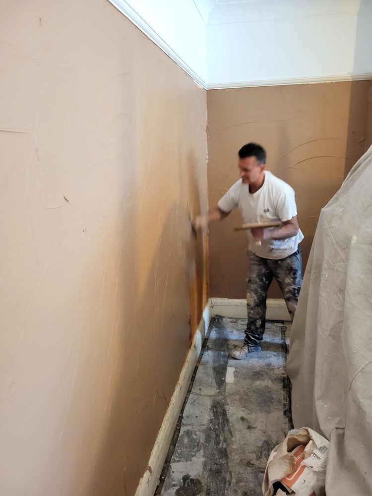 Plasterer applying a smooth internal wall finish